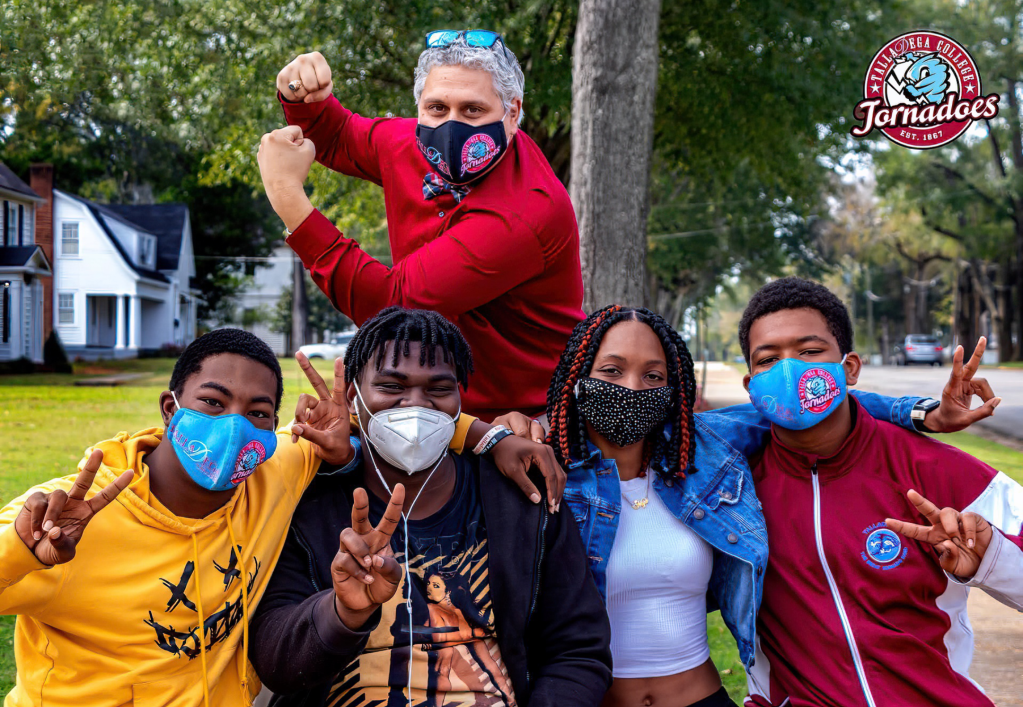 Photo of Luis Camillo and students at Talladega College. 