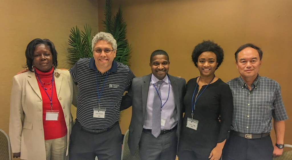 Photo of Luis Camillo and  JSU professors. 