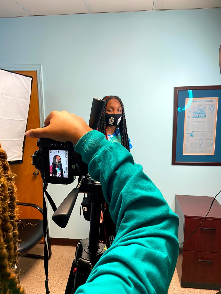 Student working collaboratively in Luis Camillo's office, engaging in projects and academic support activities