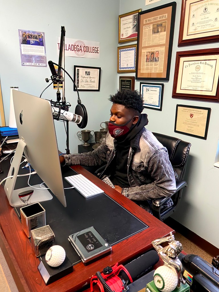 Student working collaboratively in Luis Camillo's office, engaging in projects and academic support activities