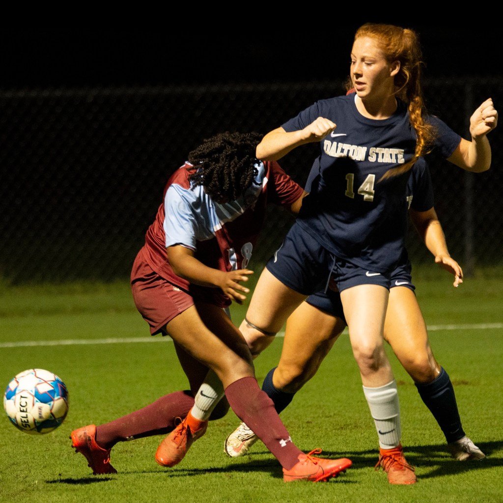 Dalton State student playing soccer, focused on the ball during a game.