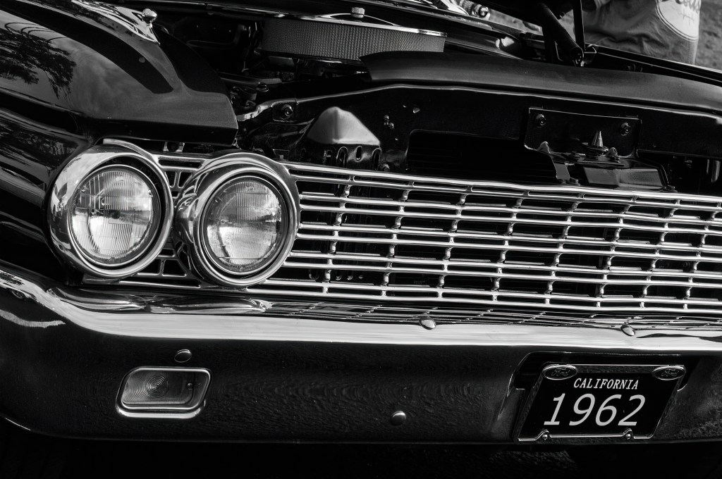 Chevrolet car on display at an auto show in California, showcased in black and white.